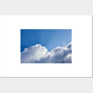 Sun rays shining behind cloud in the sky Posters and Art